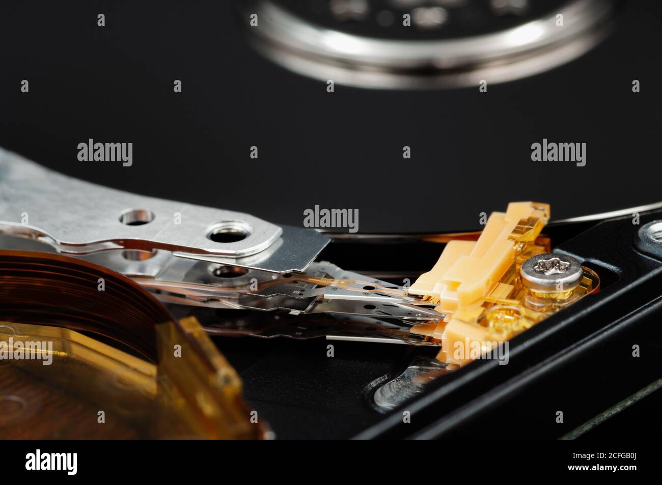 Disassembled laptop hard disk drive, hdd. Close-up. Opened hard drive, magnetic heads and disk plates. Stock Photo