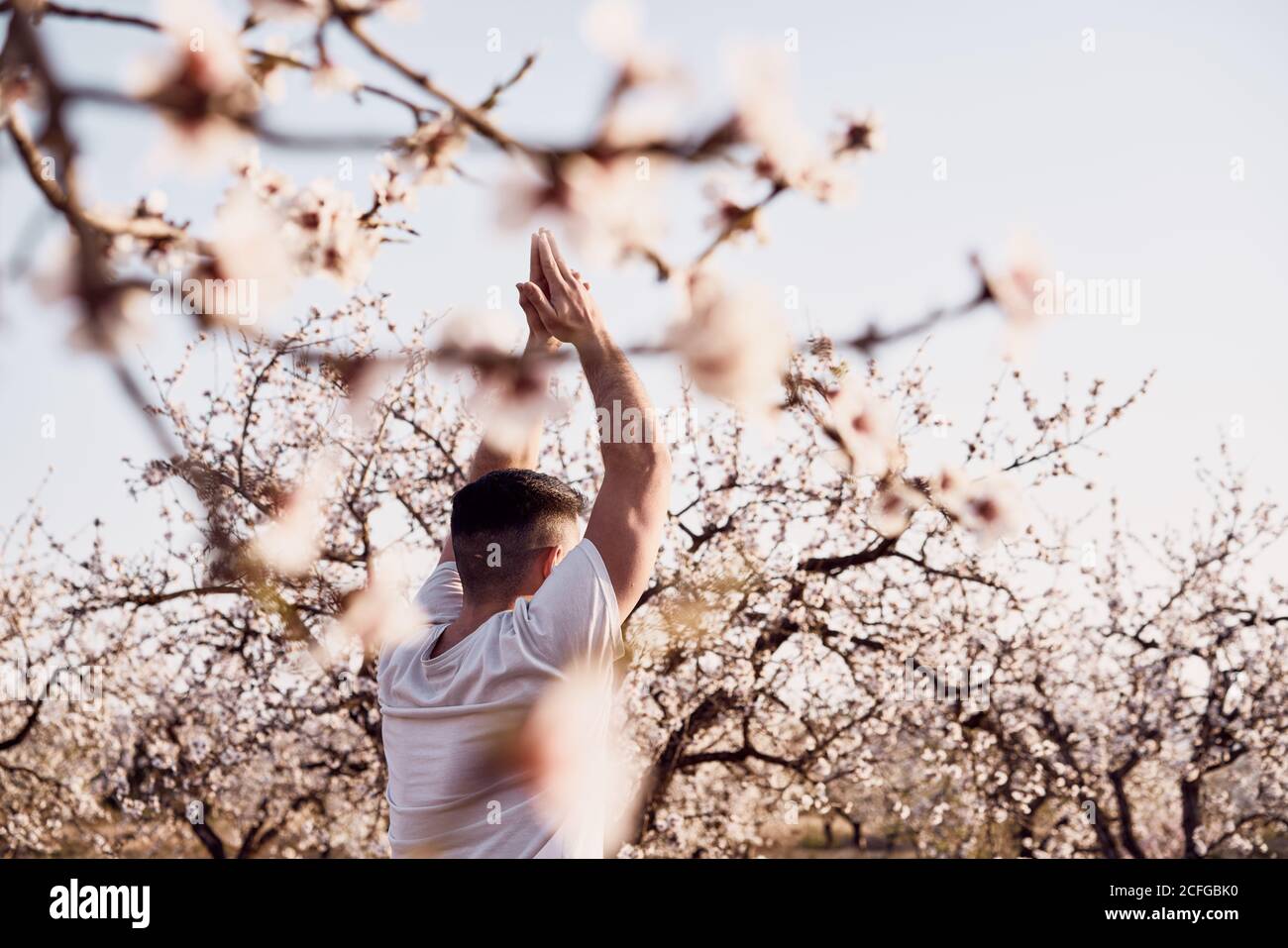 man doing yoga in spring garden Stock Photo