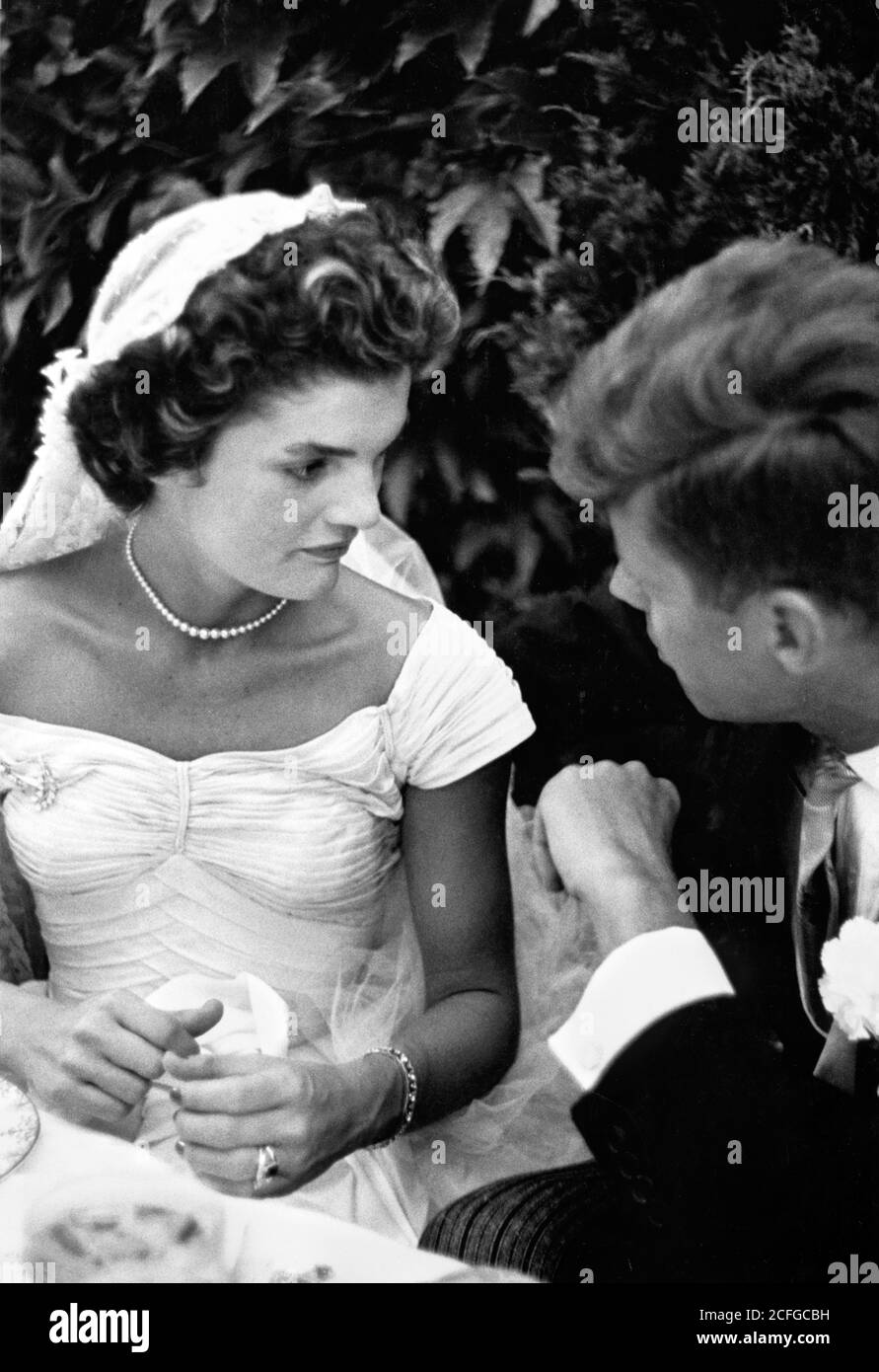 The wedding of Senator John F Kennedy to Jacqueline Bouvier in Newport, RI on September 12, 1953. The couple talking at their wedding reception. Stock Photo