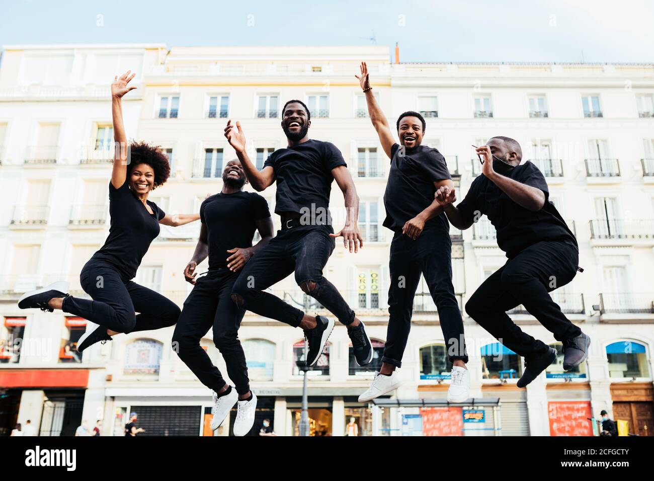 Black cool people jumping in the street and looking at camera Stock Photo
