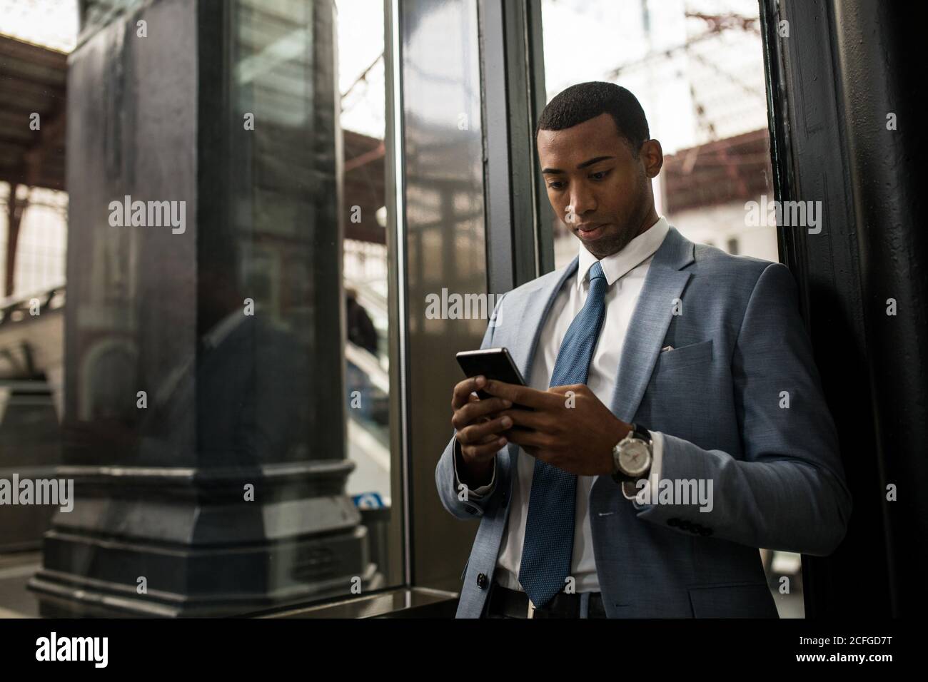Trendy black businessman using phone Stock Photo