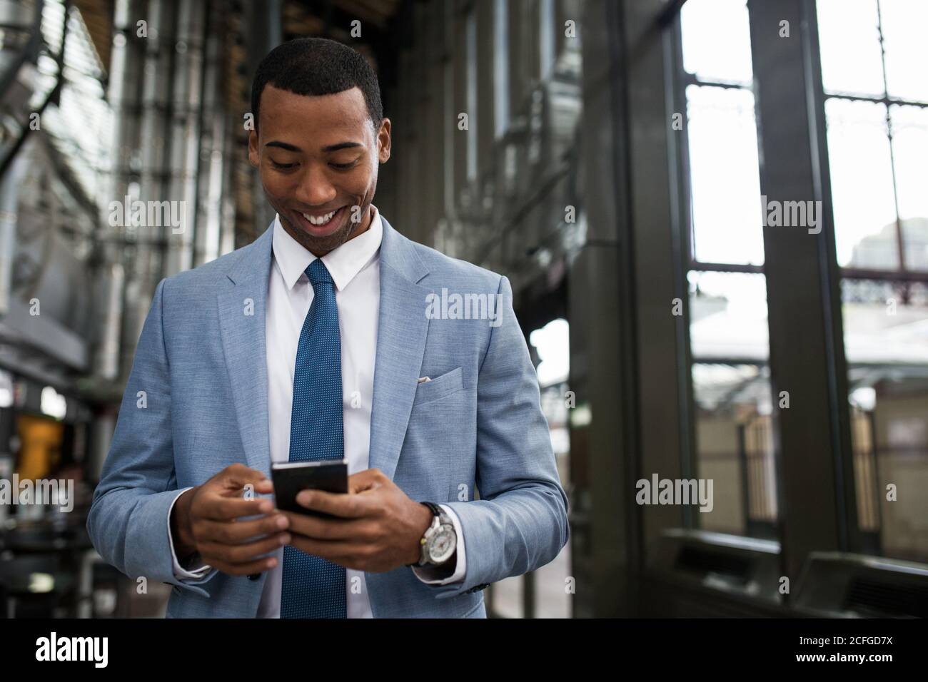 Trendy black businessman using phone Stock Photo