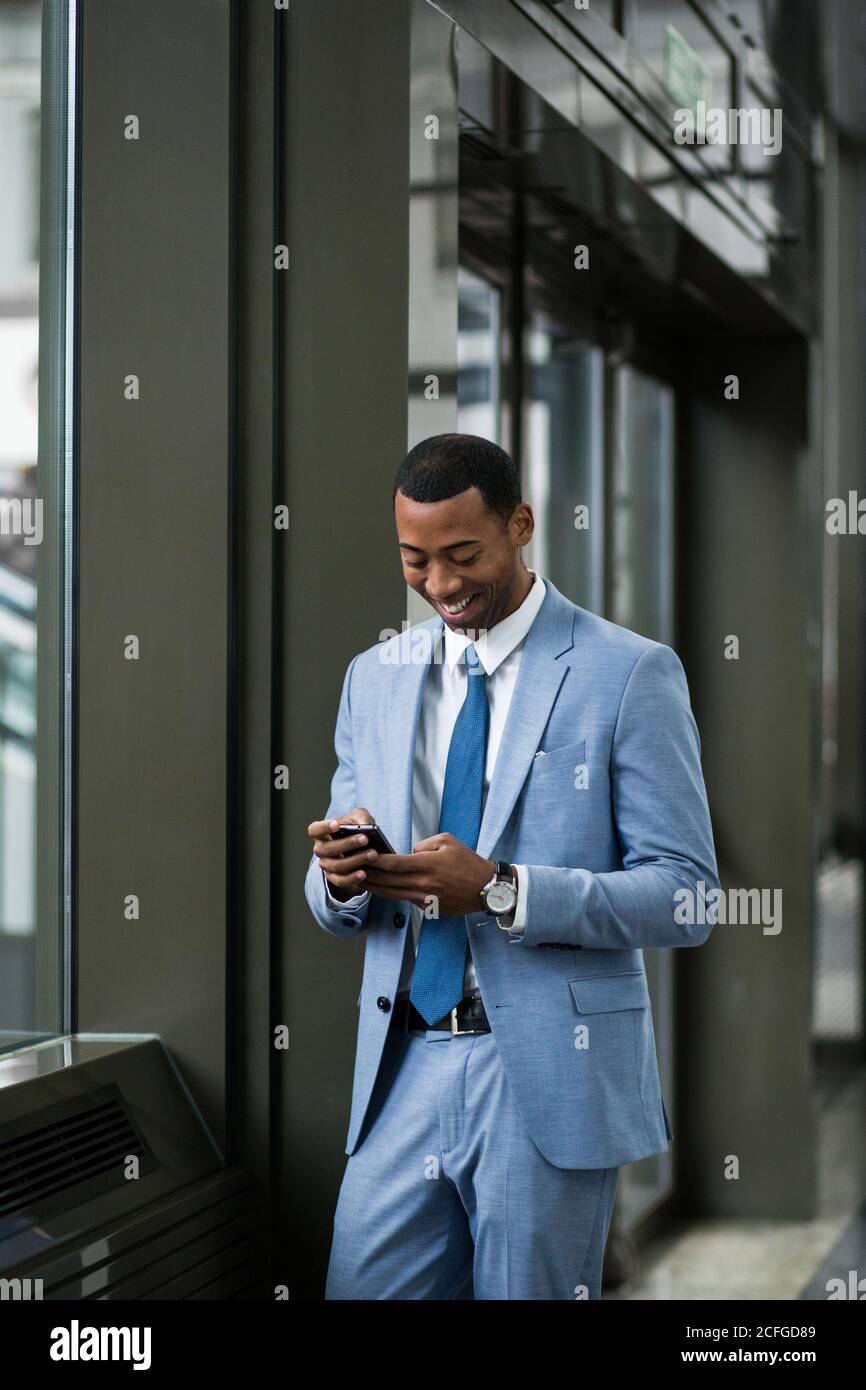 Trendy black businessman using phone Stock Photo