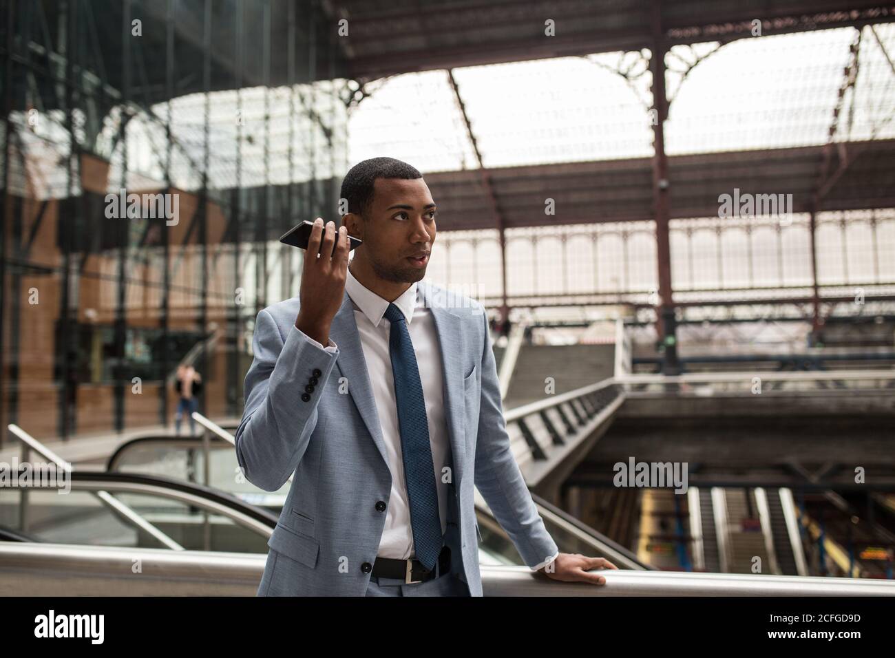 Trendy black businessman using phone Stock Photo