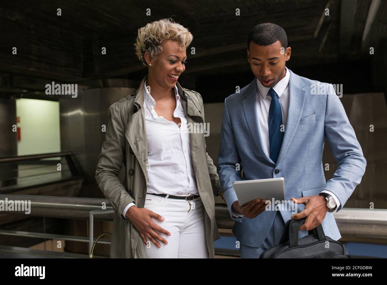Cheerful elegant African-American man and Woman watching tablet together and smiling. Stock Photo