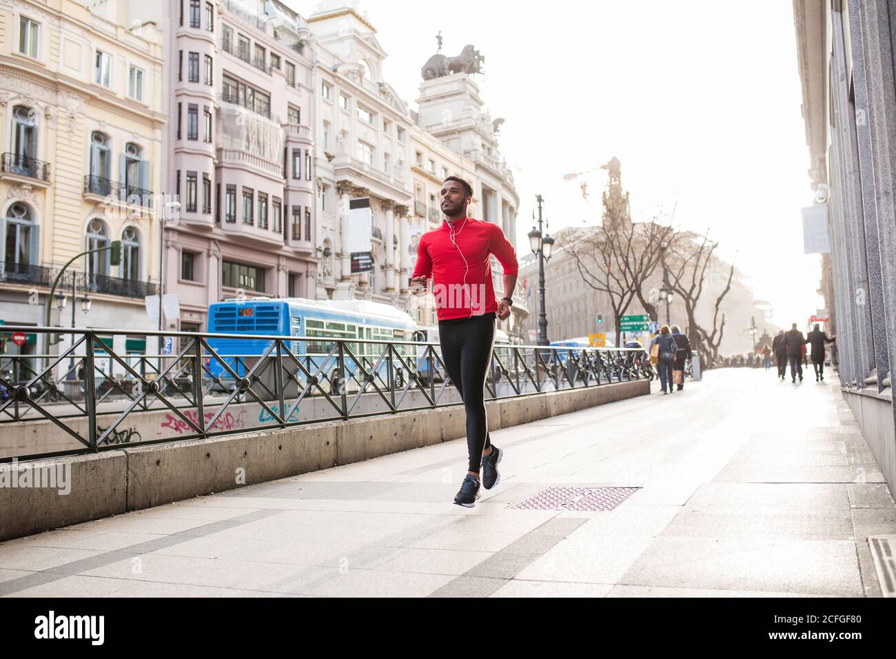 Young man running through the streets Stock Photo Alamy