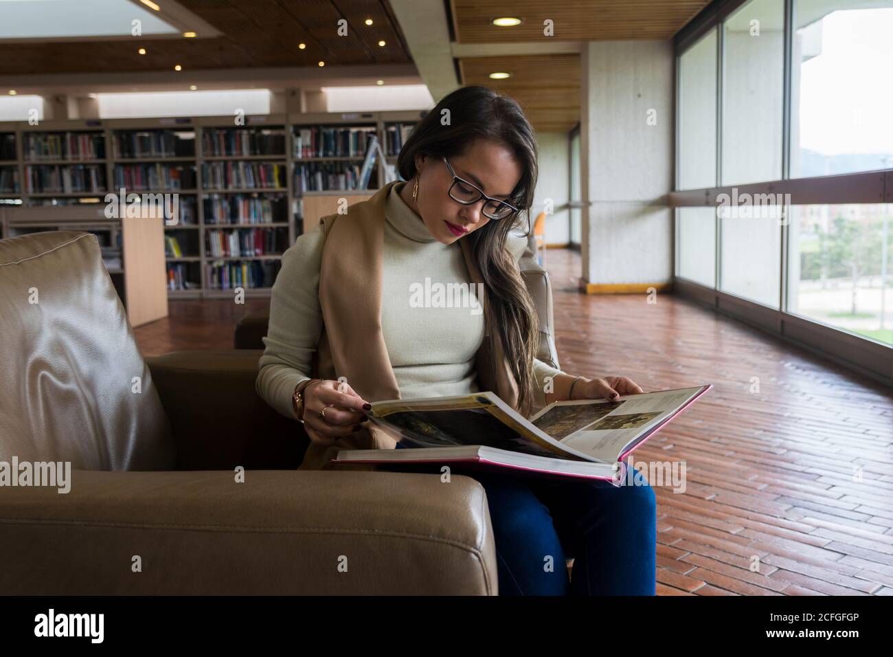 Pretty Woman in glasses reading a book Stock Photo