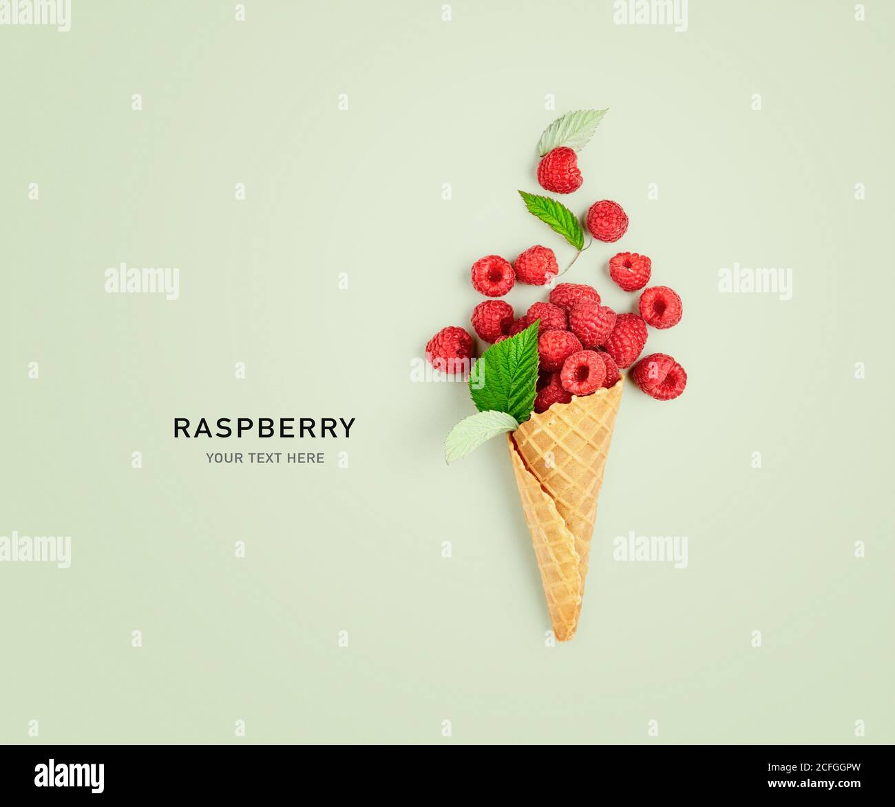 Raspberries in ice cream cone creative layout on green background ...