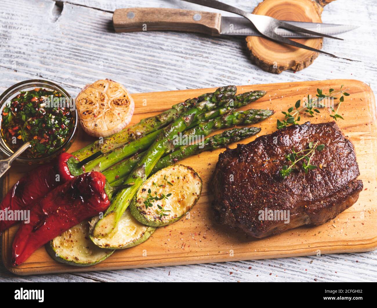 grilled beef steak, mutton with asparagus pepper on a cutting board, spices Stock Photo