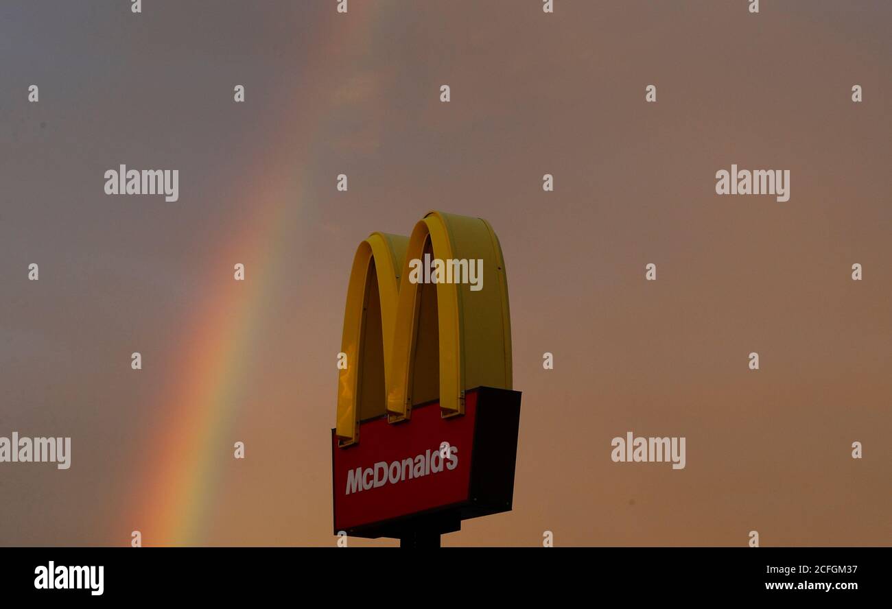 Loughborough, Leicestershire, UK. 5th September 2020. UK weather. A rainbow forms behind a McDonalds restaurant after rainfall at dusk. Credit Darren Staples/Alamy Live News. Stock Photo