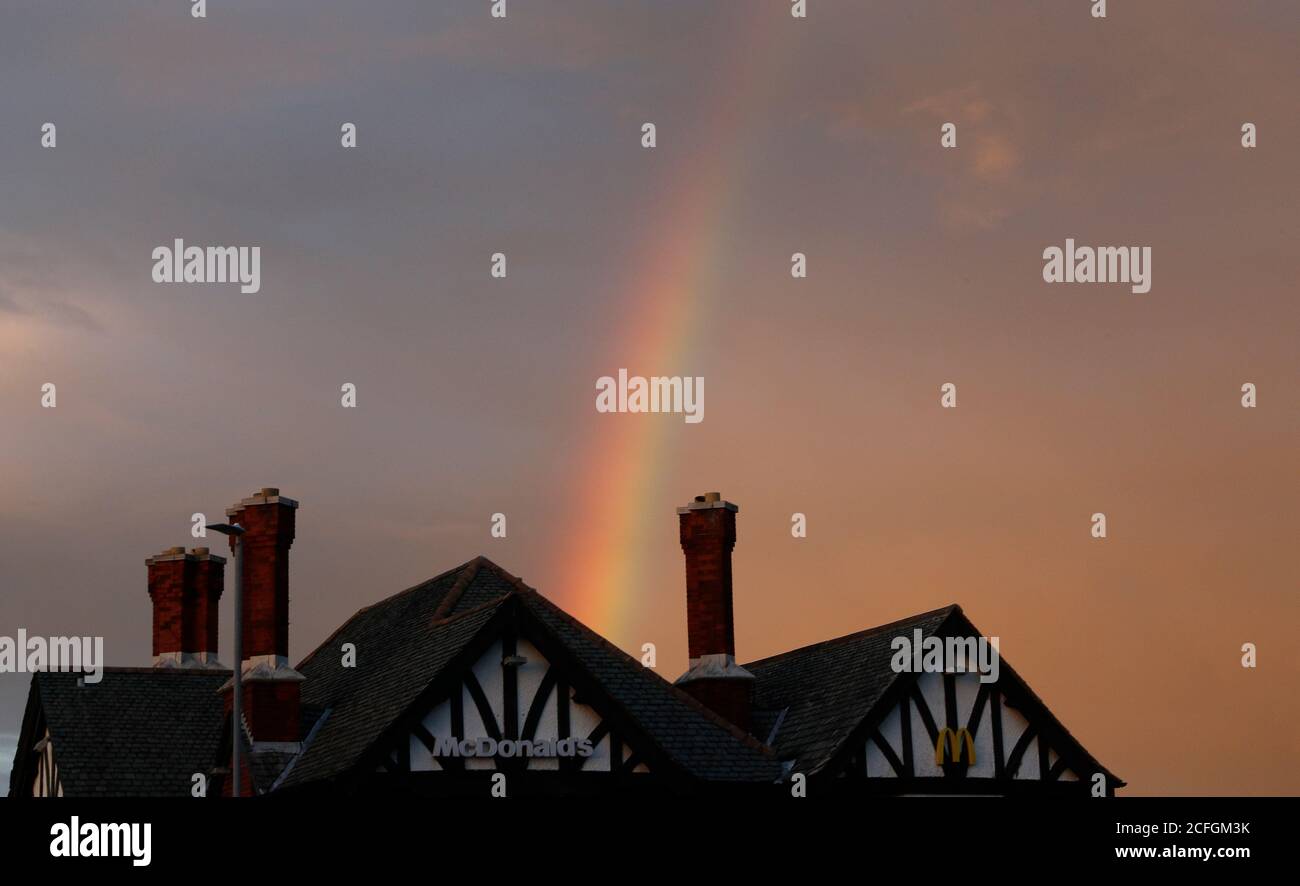 Loughborough, Leicestershire, UK. 5th September 2020. UK weather. A rainbow forms behind a McDonalds restaurant after rainfall at dusk. Credit Darren Staples/Alamy Live News. Stock Photo