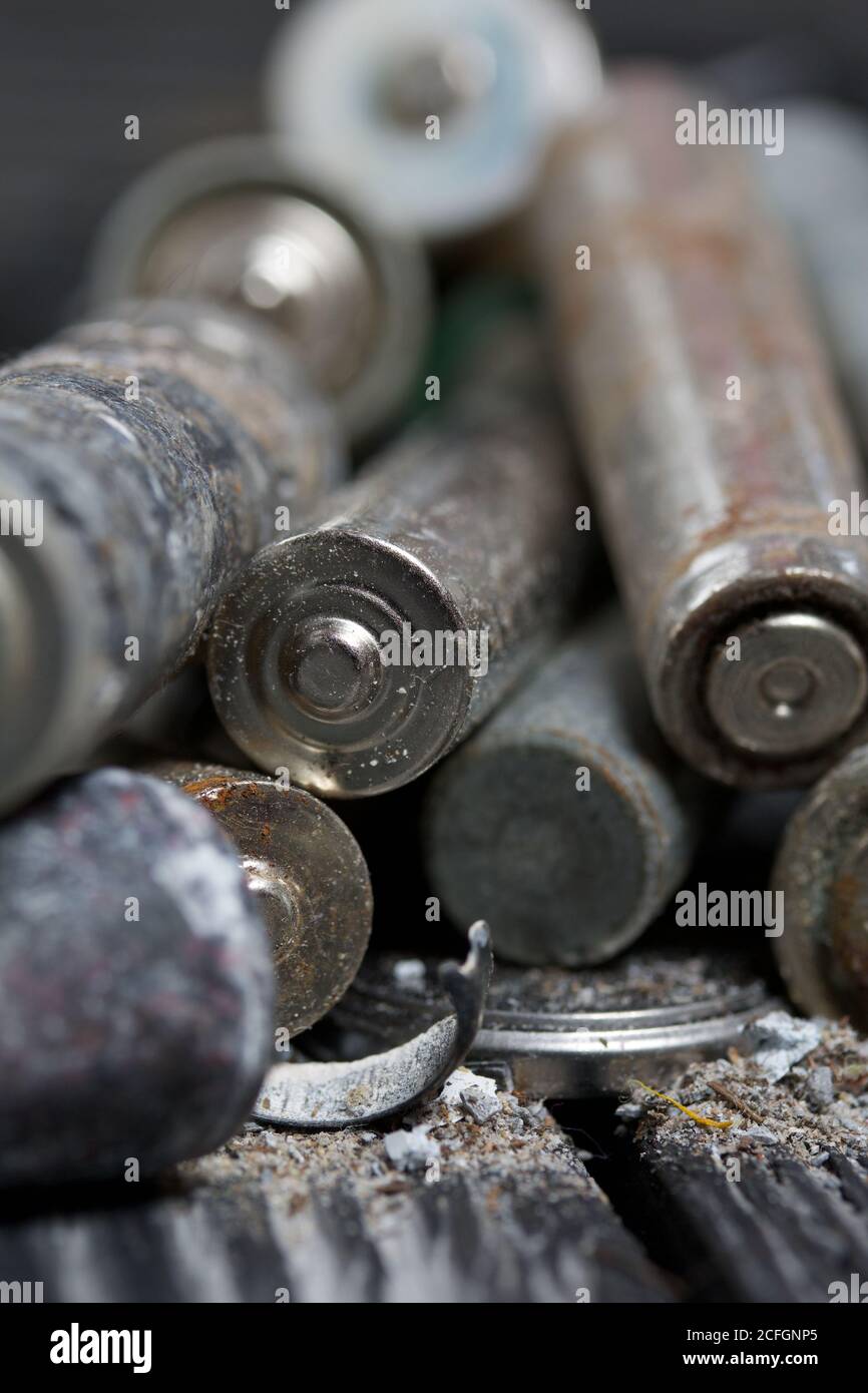 Corroded used batteries. On pine boards. Disposal of hazardous waste