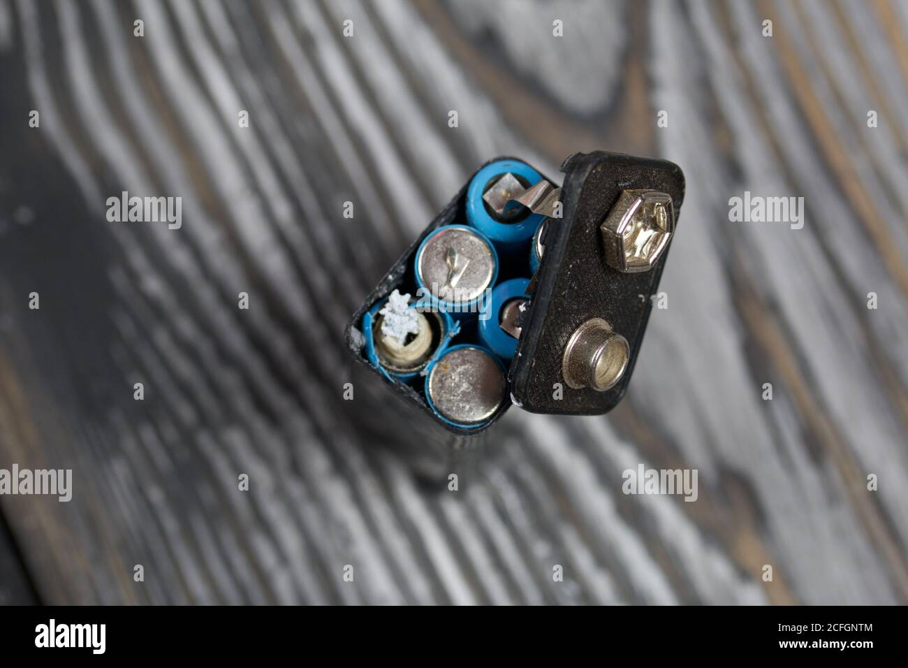 Corroded used batteries. On pine boards. Disposal of hazardous waste