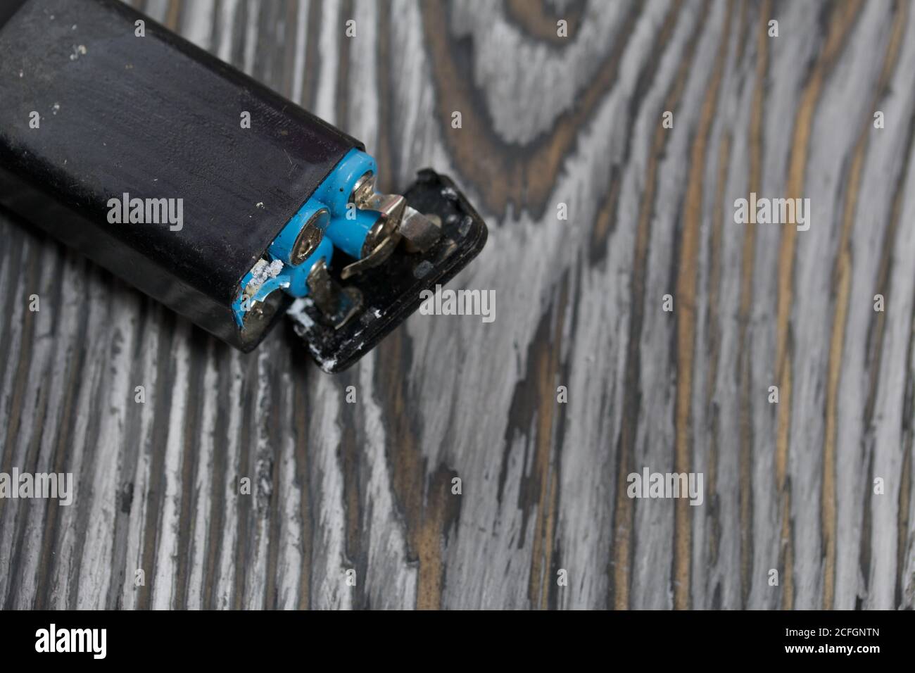 Corroded used batteries. On pine boards. Disposal of hazardous waste