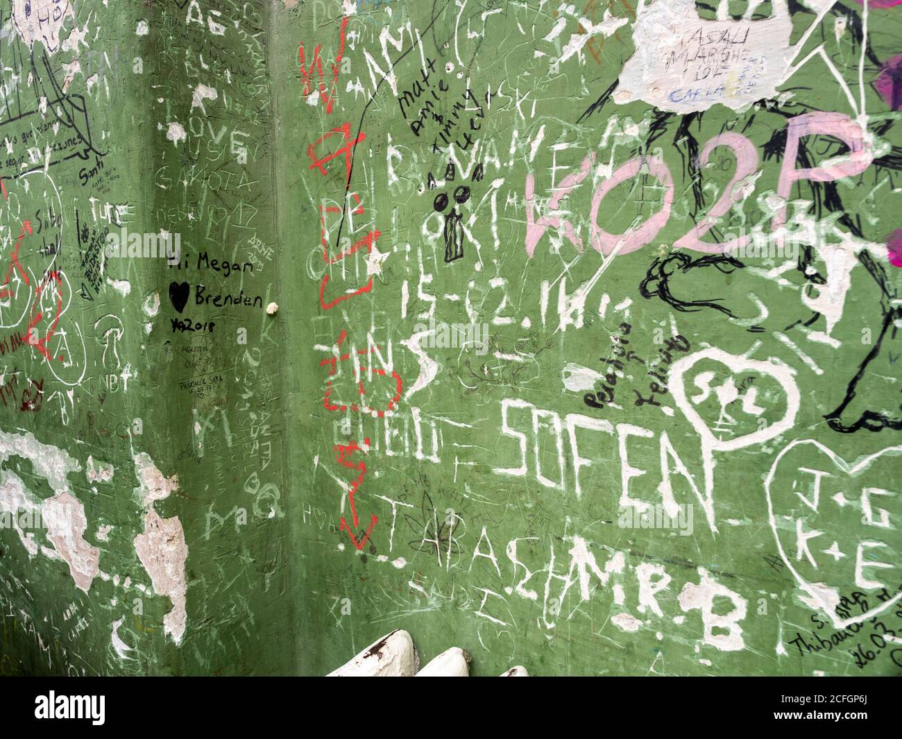 Detail of a Ruin Bar wall: A portion of the wall in the famous Szimpla Ruin Bar covered in graffiti as patrons try to leave their mark o the thick plaster and green paint of the walls. Stock Photo