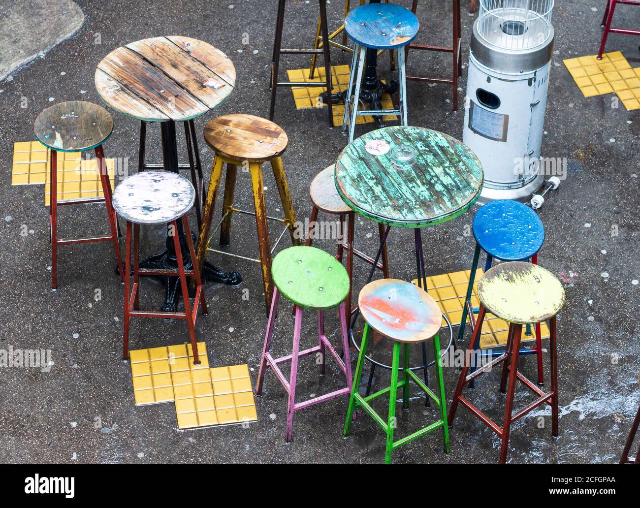 Szimpla Kertmoz bar stools in colour: Colourfully painted stools form part of the eclectic furnishings of the famous ruin bar Szimpla Kertmoz. Stock Photo