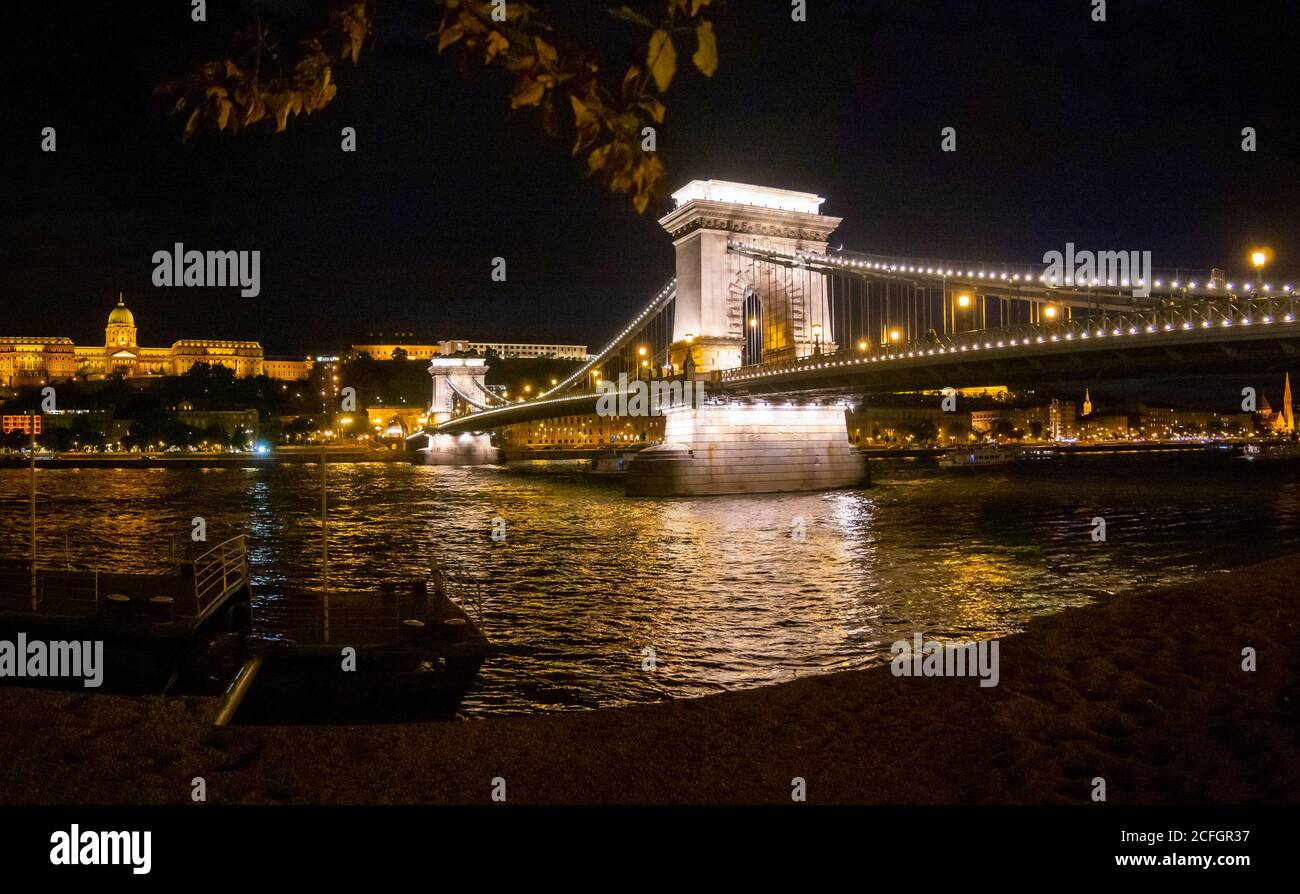 Chain Bridge over the Danube at night: The Széchenyi Chain Bridge in central Budapest with the Palace and Buda in the background all lit at night. Stock Photo