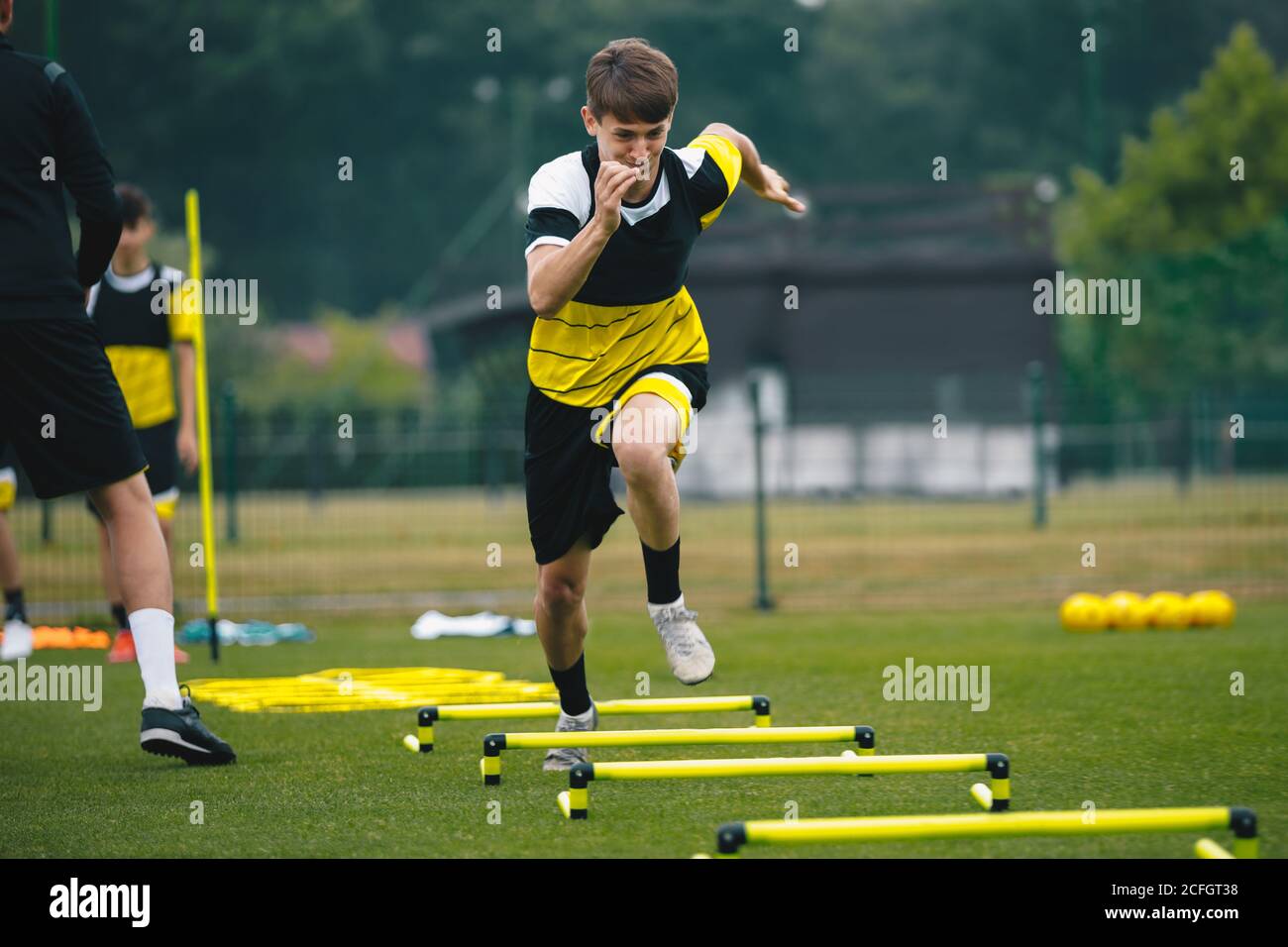 Soccer player running fast and ladder skipping. Teenagers on soccer