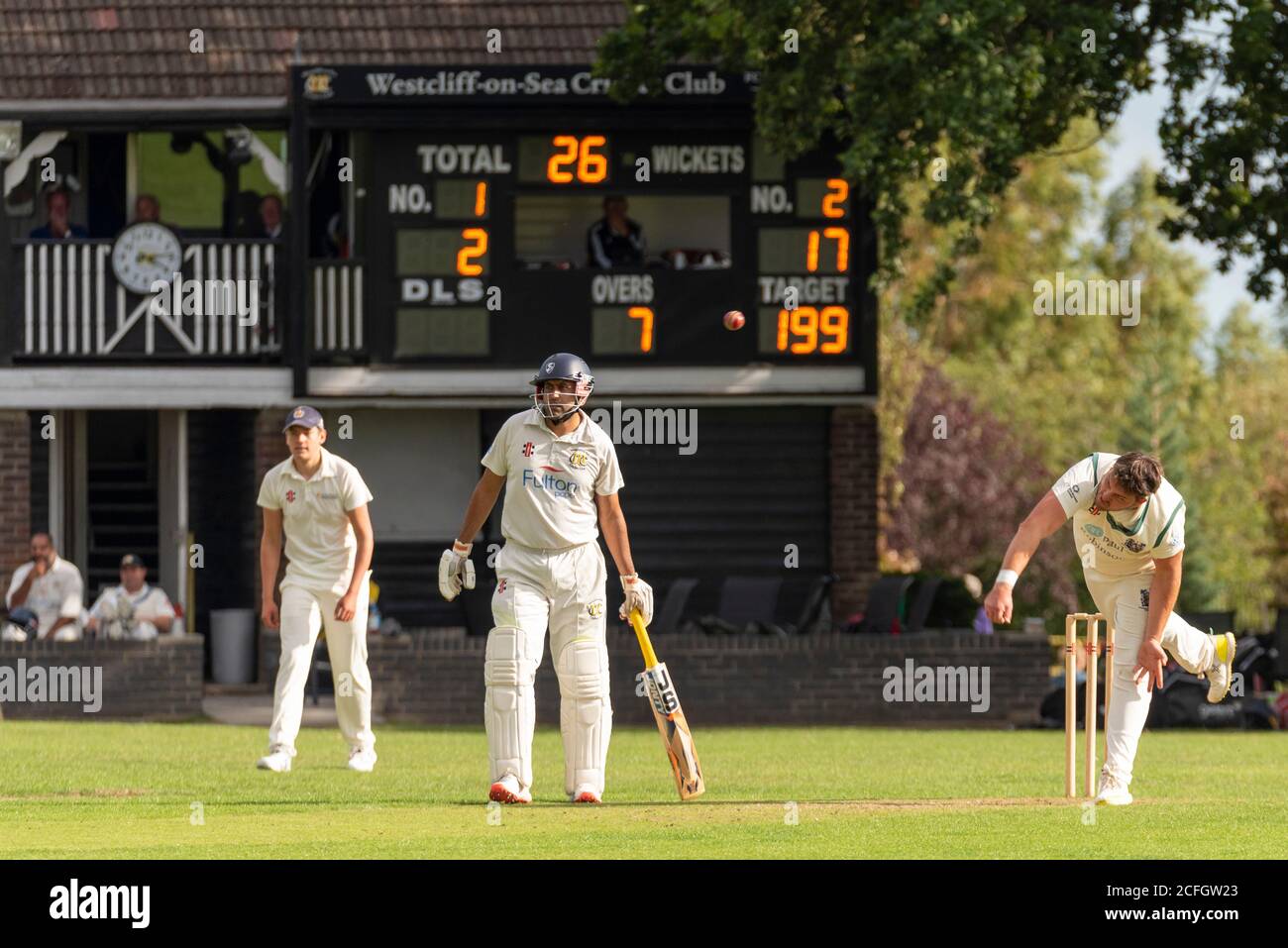 Cricket being played in Chalkwell Park, Westcliff on Sea, Southend, Essex, UK. Westcliff on Sea Cricket Club batsman, clubhouse and scoreboard Stock Photo