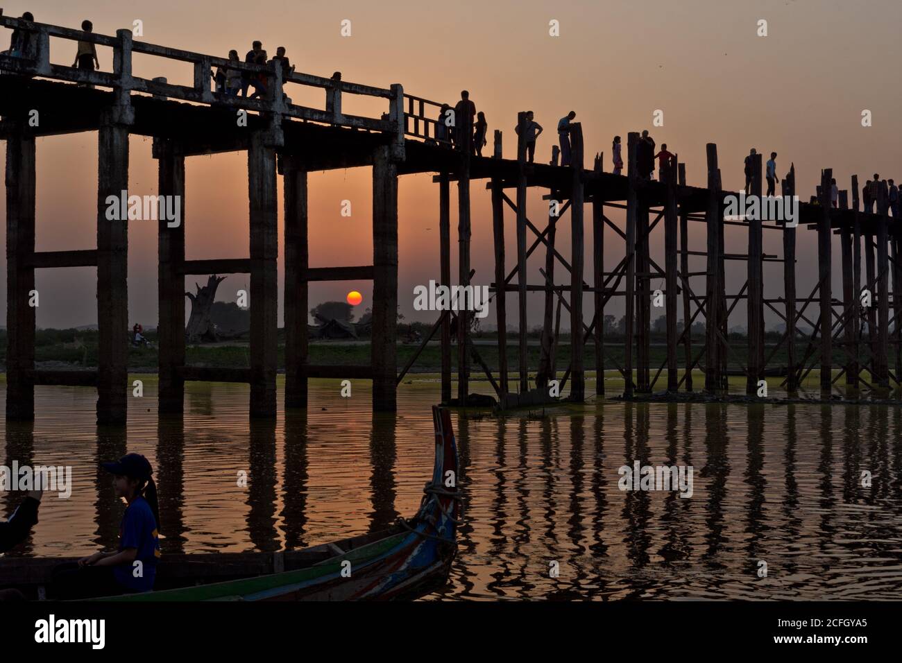 U Bein Bridge with people and sunset reflection, Amarapura, Mandalay, Myanmar, Asia Stock Photo