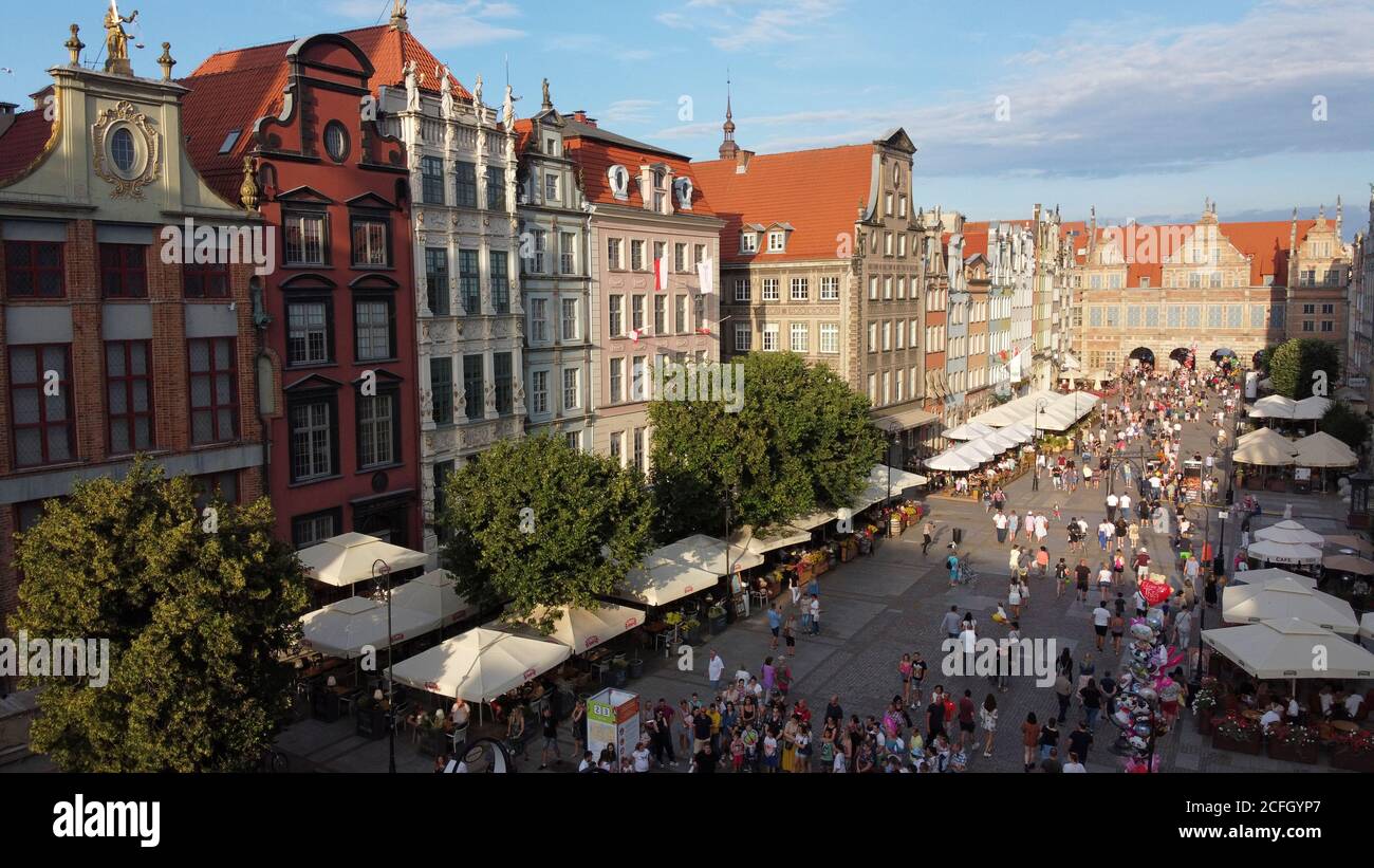 Aerial view of crowded Long Market St (Długi Targ) in Gdansk during summer evening and St Domic's Fair with beer gardens and view on the Green Gate Stock Photo