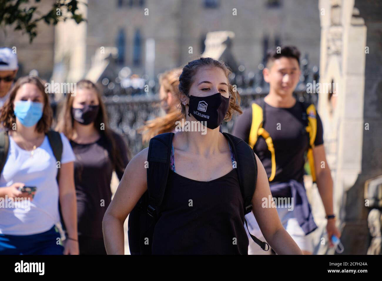 University of Ottawa students on an adventure race around the Capital as New year starts. Student with university branded mask running to next challen Stock Photo