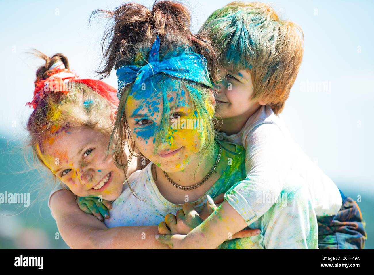 Children with paintings face. Happy children embracing each other and ...