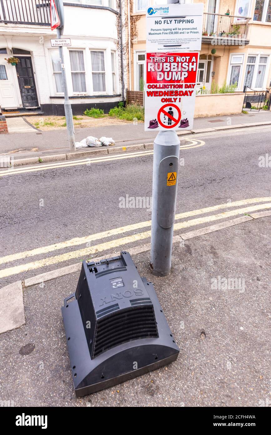 No fly tipping, this is not a rubbish dump, sign, signs, with an old, waste television dumped next to them. Street. Authentic. Defying instruction Stock Photo