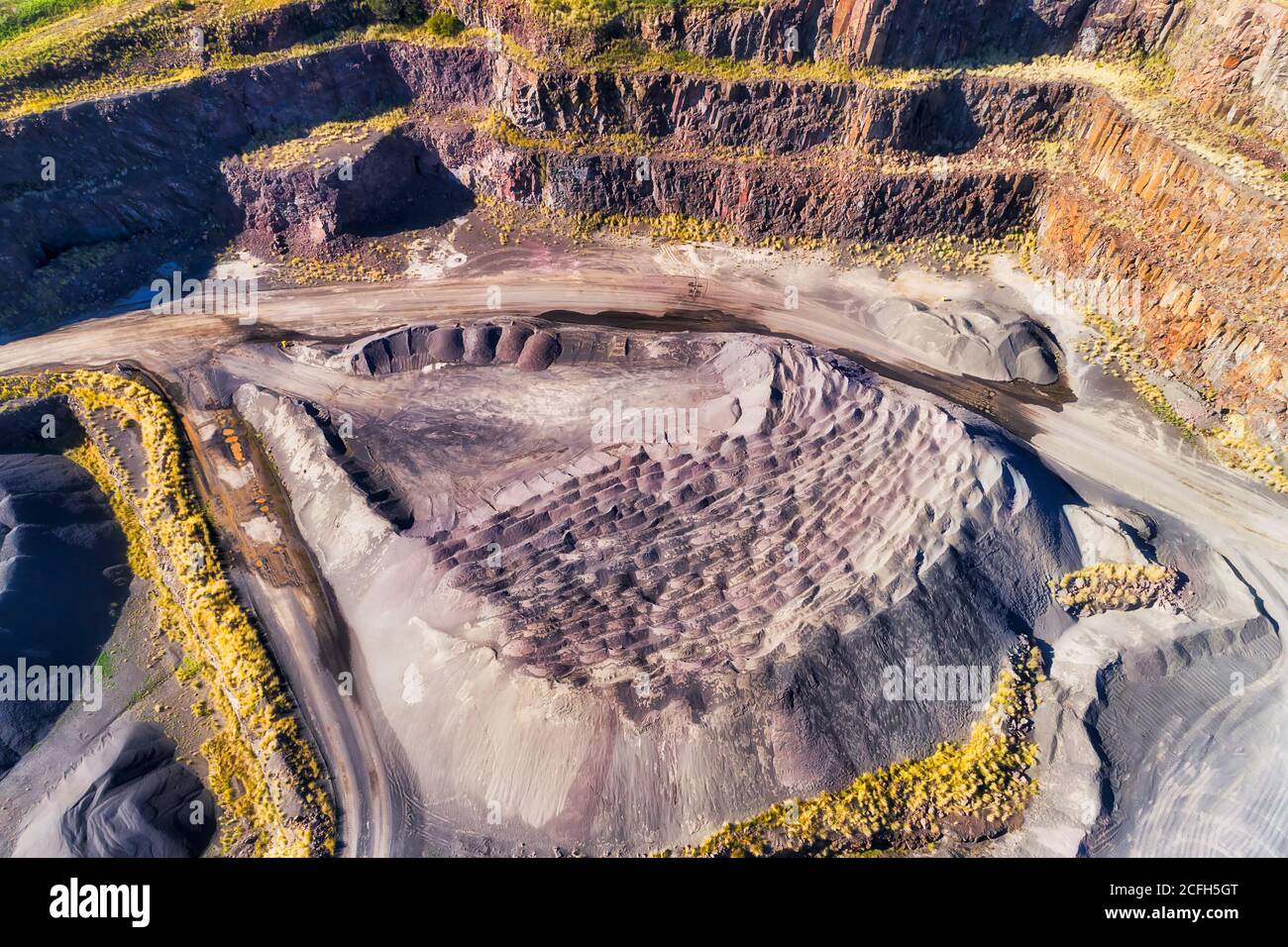 Granite quarry in Kiama town of Australia - Bombo quarry. Aerial top down view. Stock Photo