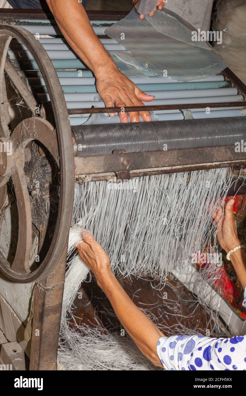 machine cutting rice cakes into noodles Stock Photo Alamy
