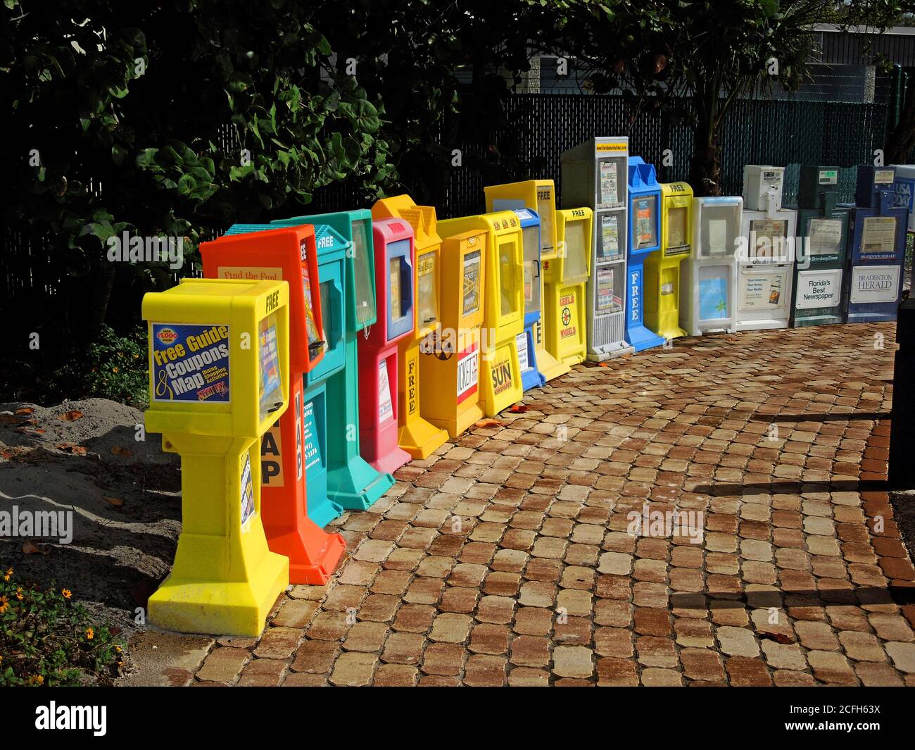 line of newspaper vending box machines Stock Photo Alamy