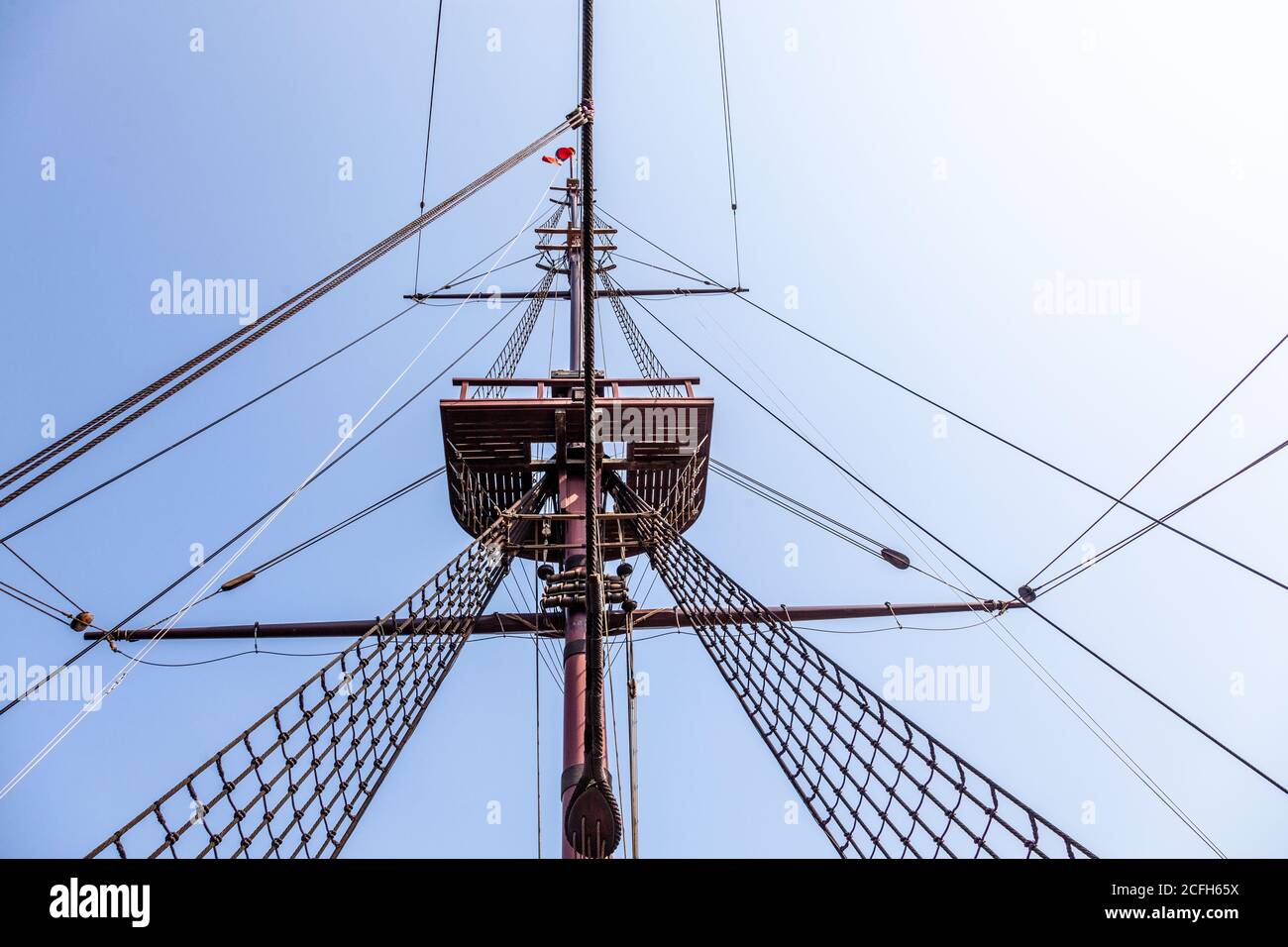 classic tall ship with rope rigging and sails. and crows nest Stock