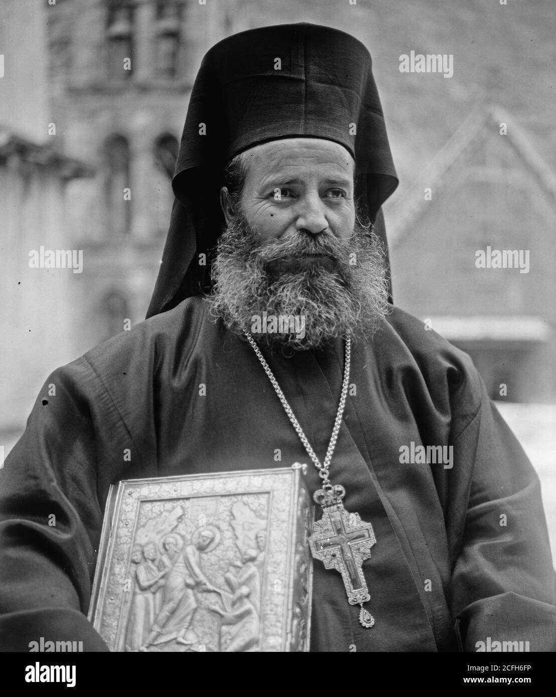 Middle East History - Greek Orthodox priest at St. Catherine's Monastery in the Sinai holding prized manuscript with silver cover from their library Stock Photo