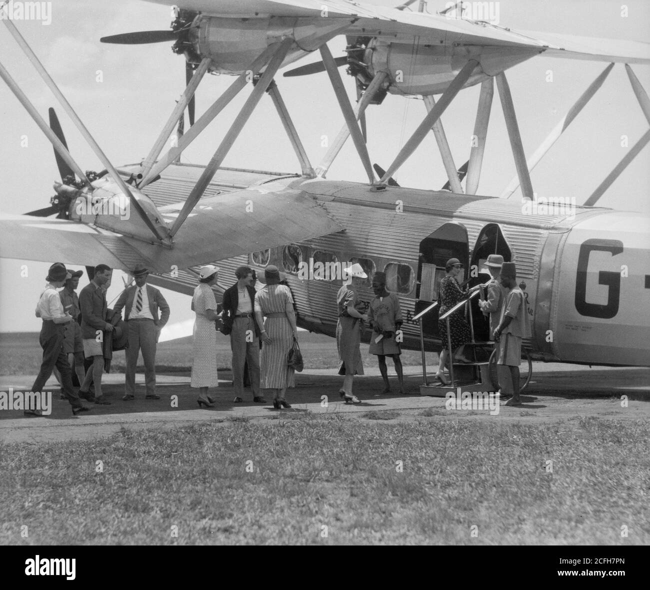 Original Caption:  Uganda. Crossing the Victoria Lake into Kenya. Passengers boarding the plane about to take off from Entebbe  - Location: Uganda ca.  1936 Stock Photo