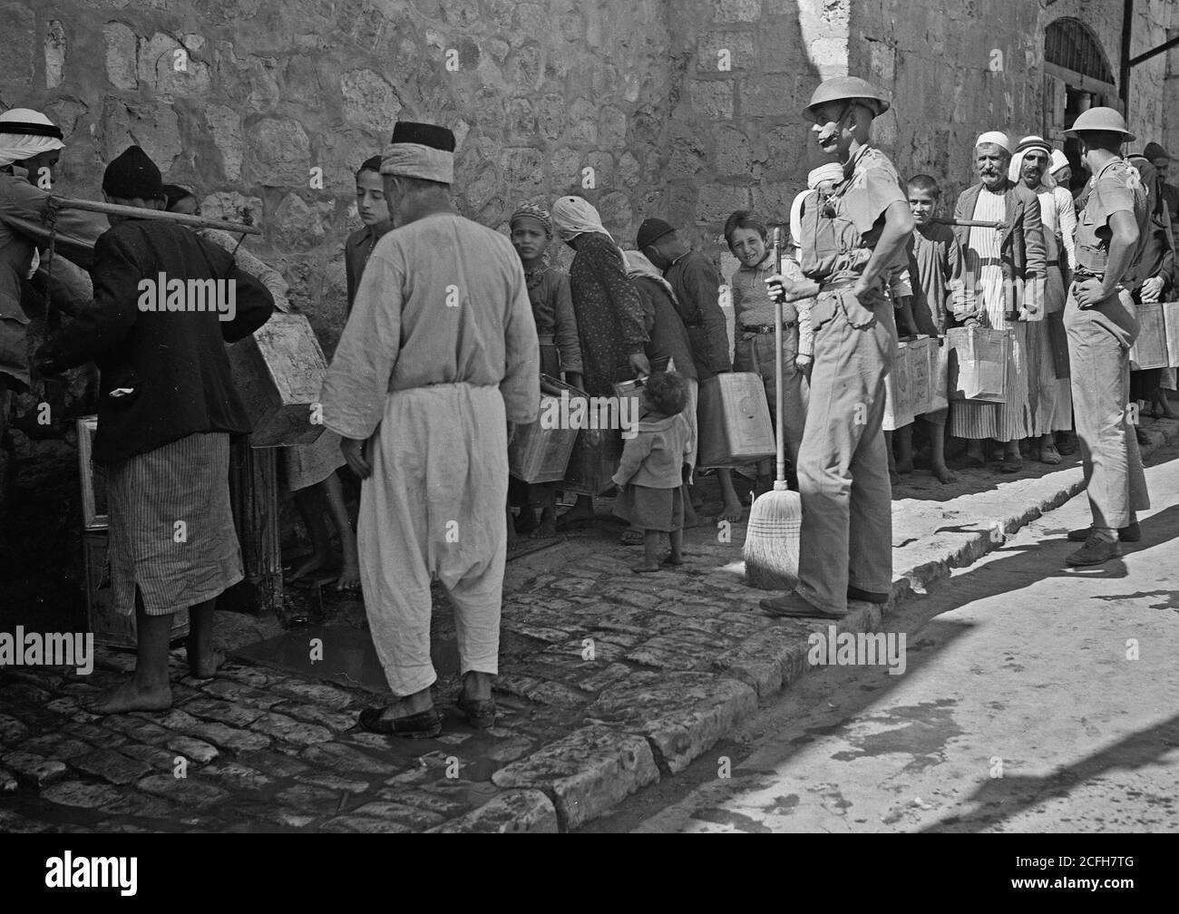 Middle East History - The raising of the siege of Jerusalem. Thirsty people lined up to get their supply of drinking water inside the Old City Stock Photo