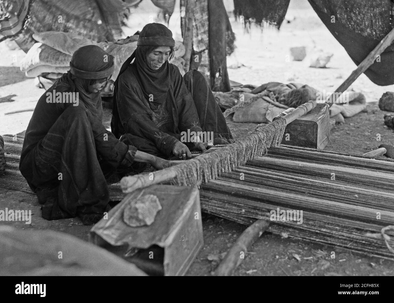 Original Caption:  Bedouin women weaving  - Location:  ca.  1940-1946 Stock Photo