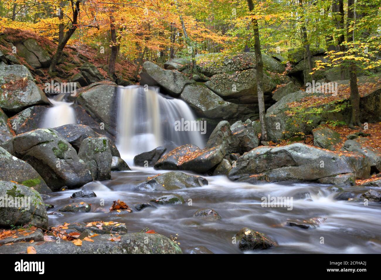 Autumn in New England. Fall foliage, scenic waterfall (Trap Falls), large boulders, and rushing brook in Willard Brook State Forest, Massachusetts. Stock Photo