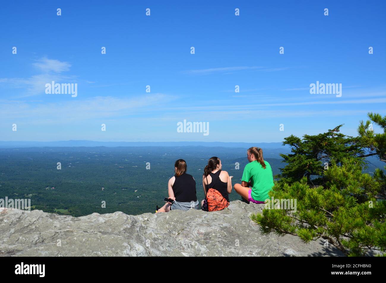 Hikers take in the view from atop Moore's Knob in Hanging Rock State Park, North Carolina. Stock Photo