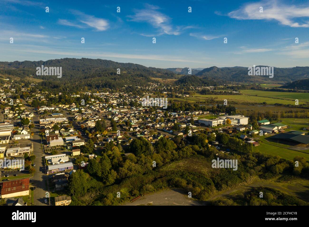 Aerial of small town Myrtle Point in Southern Oregon and green fields
