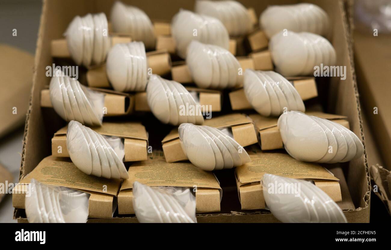 Disposable plastic tableware, picnic cutlery. Shelves in the store with