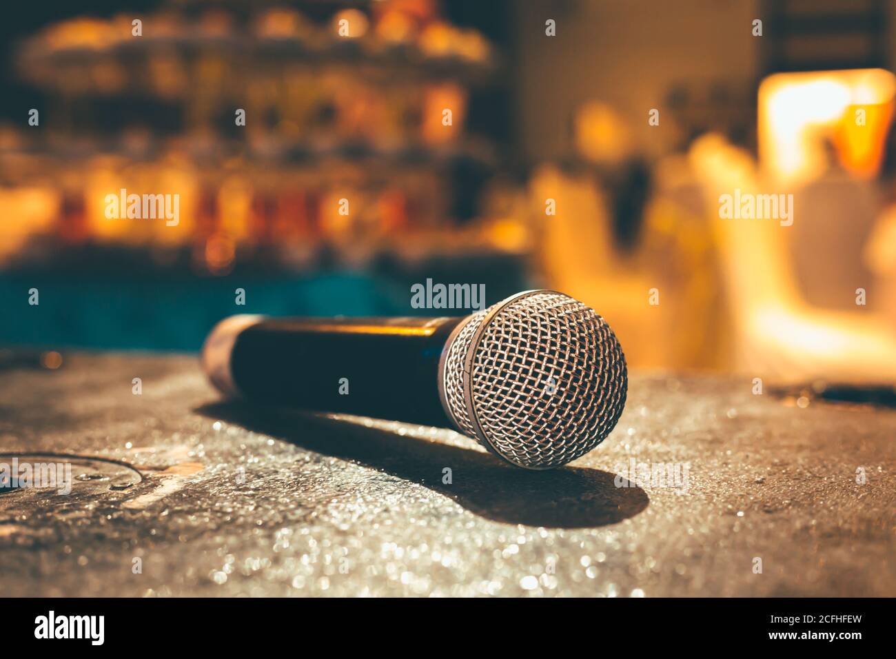 Microphone on the ground and blurred photo of conference hall or