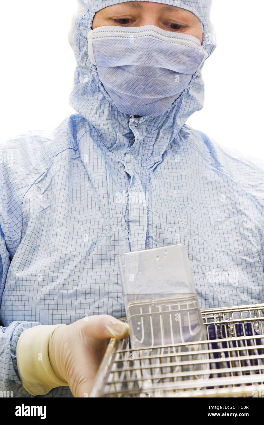 biotechnology researcher in protect wear with mouses Stock Photo
