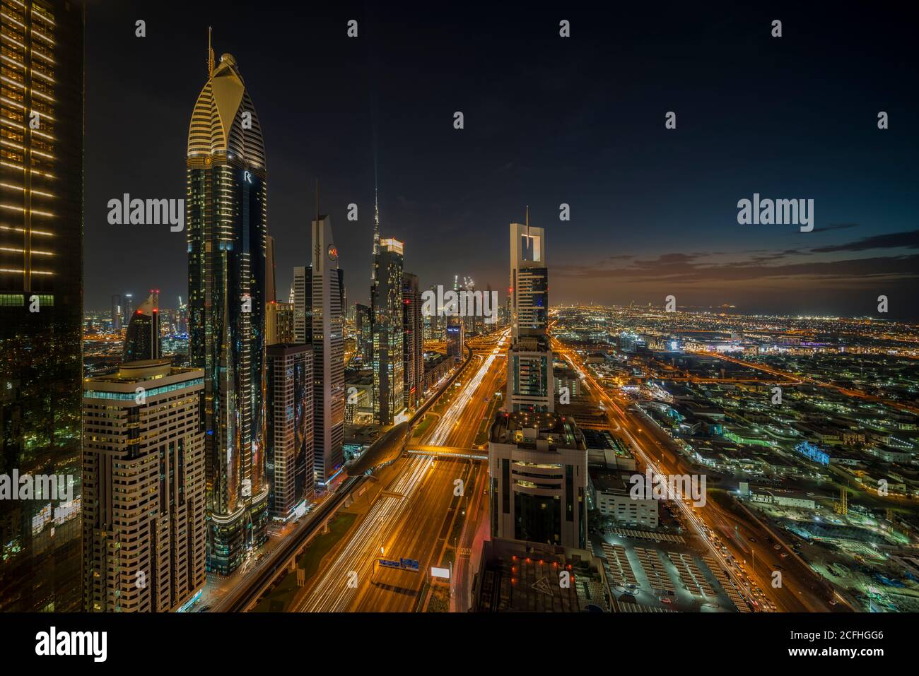 A view of the city skyline at dusk from the financial district of downtown Dubai, UAE, Middle East. Stock Photo