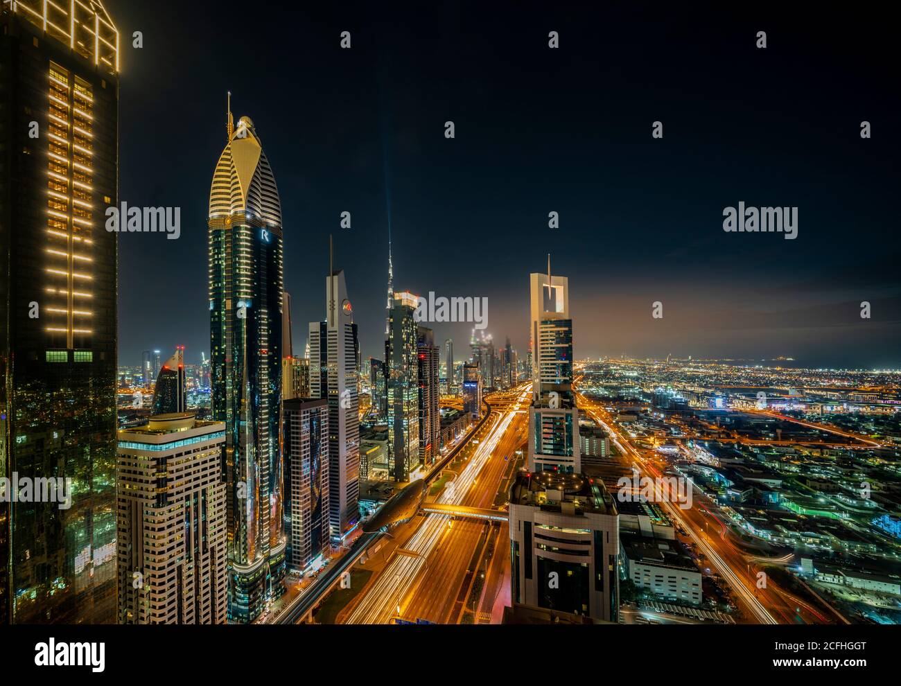 A view of the city skyline at dusk from the financial district of downtown Dubai, UAE, Middle East. Stock Photo