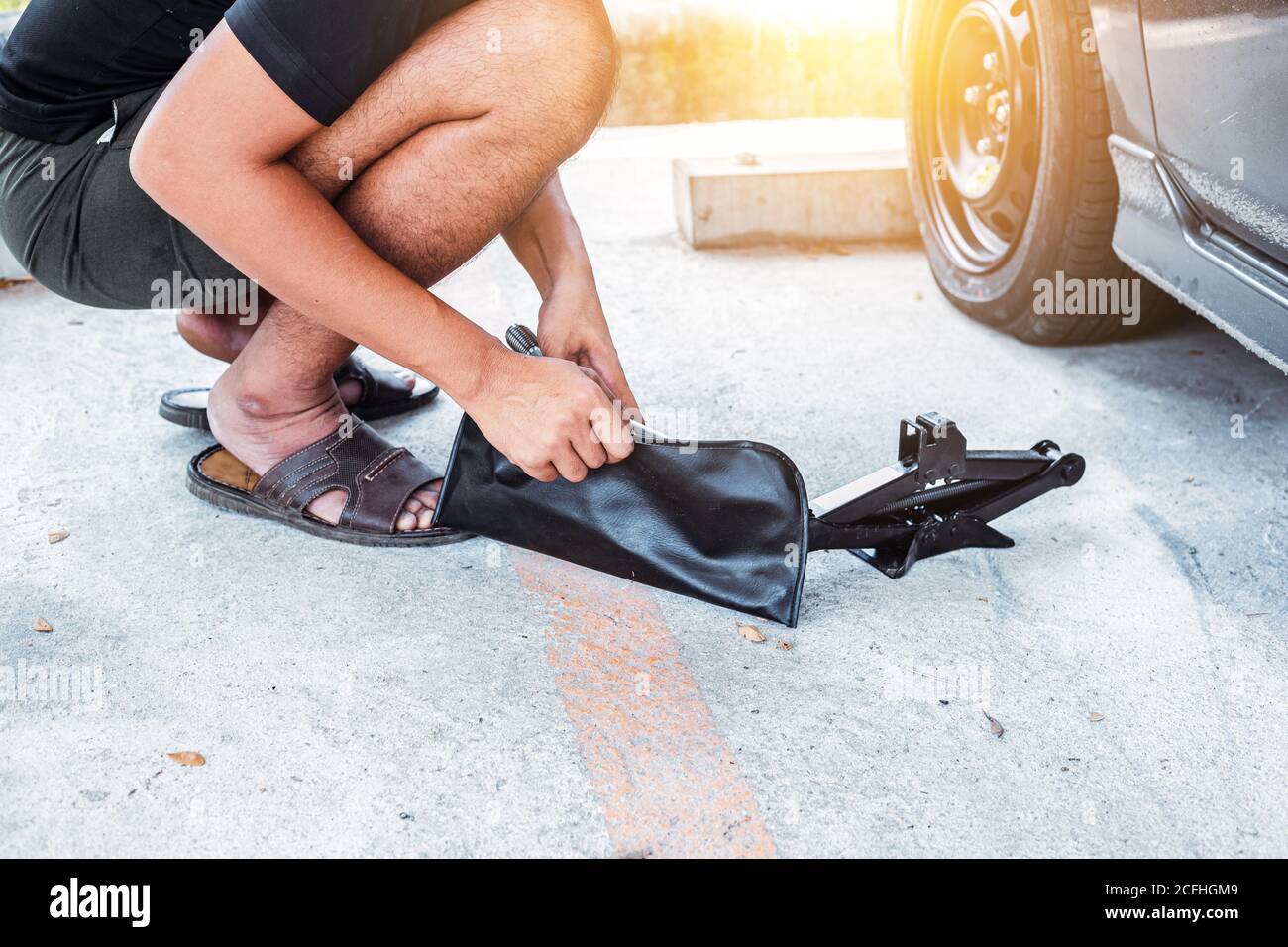 Car tire changed for maintenance in garage using hydraulic jack car maintenance concept Stock