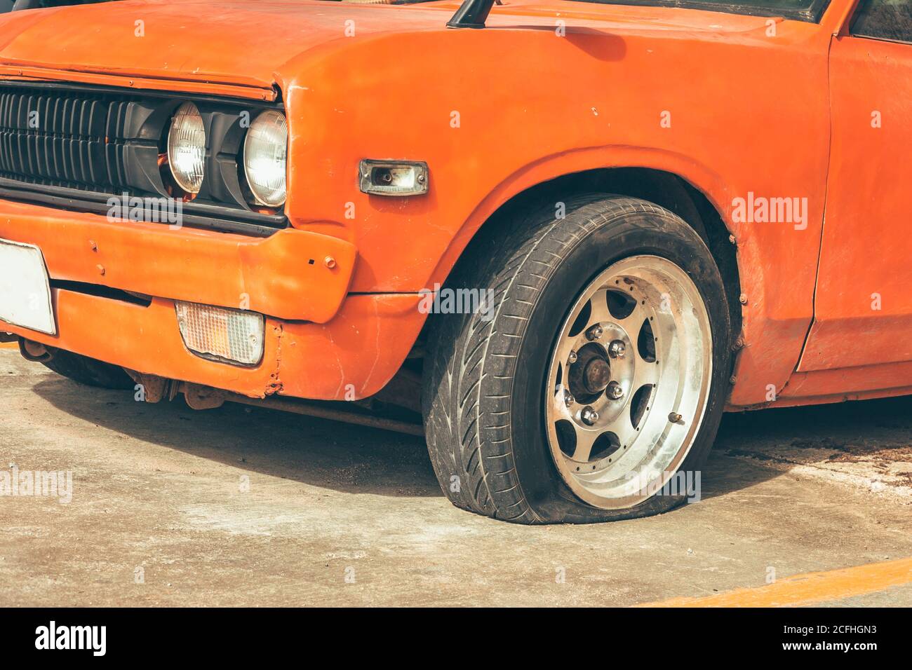 car wheel flat tire on the road in the city. Stock Photo