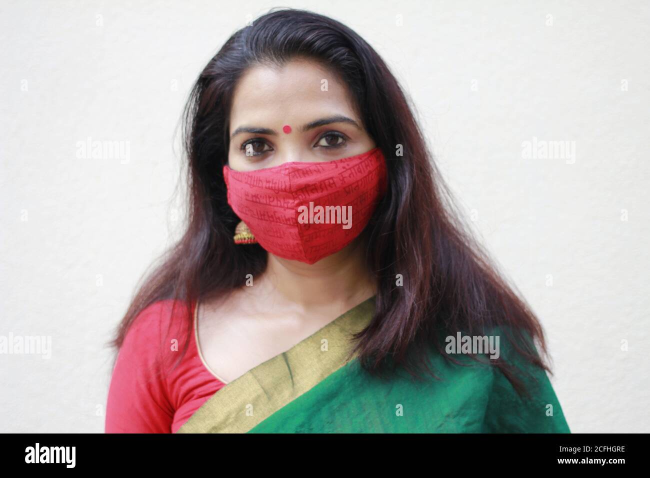 Beautiful Indian woman wearing cotton cloth face mask as a precaution from COVID-19 Stock Photo