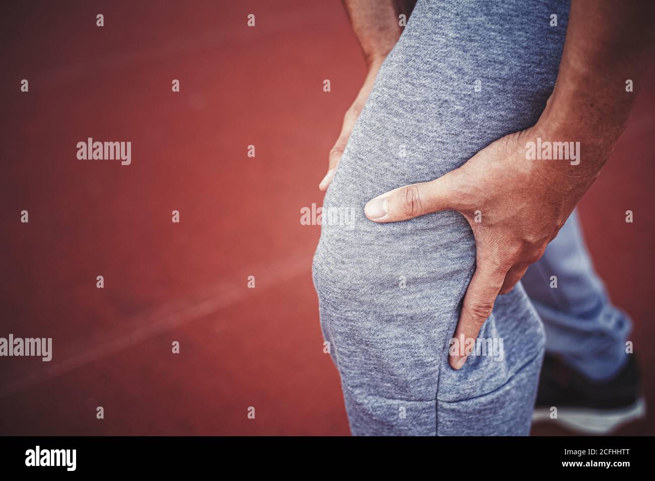 Athlete suffering form running knee or kneecap injury during outdoor