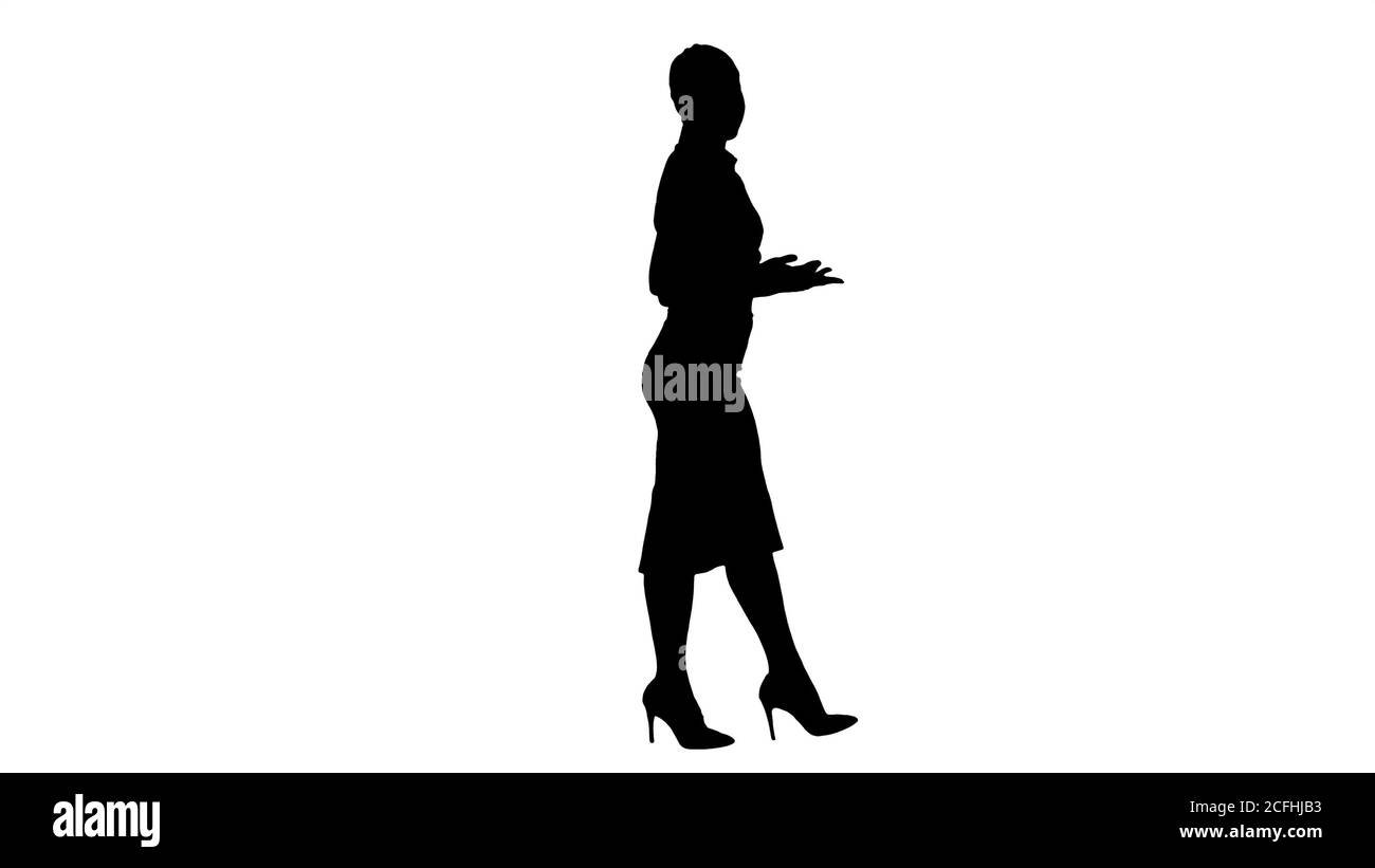 Silhouette Business woman strongly going forward and talking to camera. Stock Photo