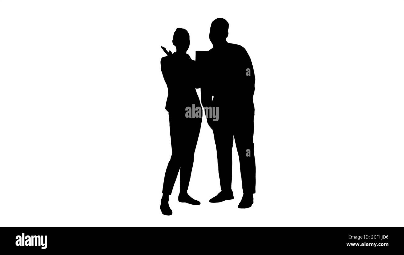 Silhouette Young caucasian businesswoman and her african colleague making video call with tablet. Stock Photo